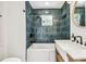 Bathroom featuring trendy green tile, modern fixtures, a shower-tub combination, and a custom wooden vanity at 6401 N Central Ave, Tampa, FL 33604