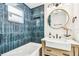 Bathroom boasts stylish tile, wooden vanity with farmhouse sink, modern lighting, and a bathtub with shower at 6401 N Central Ave, Tampa, FL 33604
