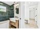 Updated bathroom features stylish tiles, wooden vanity with farmhouse sink, and a shower-tub combination at 6401 N Central Ave, Tampa, FL 33604