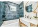 Bathroom with modern shower and tub, updated vanity, trending tile, and great natural light at 6401 N Central Ave, Tampa, FL 33604
