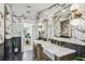 Modern bathroom featuring dual sinks, marble walls, and stylish fixtures, creating a luxurious and elegant space at 6401 N Central Ave, Tampa, FL 33604