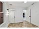 A spacious bedroom features herringbone floors, updated lighting, and freshly painted walls at 6401 N Central Ave, Tampa, FL 33604