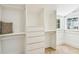Bright and airy closet space with built-in shelving, drawers, and natural light from a window at 6401 N Central Ave, Tampa, FL 33604