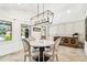 Bright dining room featuring a marble table, stylish light fixture, and wood floors at 6401 N Central Ave, Tampa, FL 33604