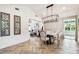 Bright dining room features herringbone floors, a modern chandelier and views into the living room at 6401 N Central Ave, Tampa, FL 33604