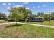 Charming single-story home with a well-manicured lawn and attached garage at 6401 N Central Ave, Tampa, FL 33604