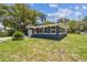 Charming single-story home with a well-manicured lawn and attached garage at 6401 N Central Ave, Tampa, FL 33604