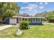 Charming single-story home with a well-manicured lawn and attached garage at 6401 N Central Ave, Tampa, FL 33604