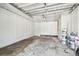 Attached garage with painted walls and ceiling, unfinished floor, and ample space for parking or storage at 6401 N Central Ave, Tampa, FL 33604