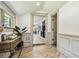 Hallway featuring neutral walls, herringbone floors, and view into kitchen at 6401 N Central Ave, Tampa, FL 33604