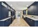 Elegant kitchen boasts navy cabinetry, farmhouse sink, and stainless steel appliances at 6401 N Central Ave, Tampa, FL 33604
