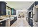 Spacious kitchen featuring navy cabinets, stainless steel appliances, and an open floor plan at 6401 N Central Ave, Tampa, FL 33604