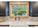Modern kitchen featuring a farmhouse sink, black faucet, and natural wood trim at 6401 N Central Ave, Tampa, FL 33604