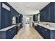 Elegant kitchen boasts navy cabinetry, farmhouse sink, and stainless steel appliances at 6401 N Central Ave, Tampa, FL 33604