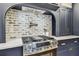 Stainless steel range features modern hood and pot filler against a whitewashed brick backsplash at 6401 N Central Ave, Tampa, FL 33604