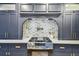 Stainless steel range features modern hood and pot filler against a whitewashed brick backsplash at 6401 N Central Ave, Tampa, FL 33604