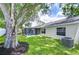 Spacious backyard featuring a screened-in lanai, shade trees, and well-maintained lawn at 6720 Gilda Dr, Tampa, FL 33625