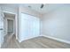 Clean bedroom featuring wood-look flooring and closet space with a double door at 6720 Gilda Dr, Tampa, FL 33625