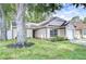 Charming single-Gathering home featuring an attached garage and well-maintained landscaping at 6720 Gilda Dr, Tampa, FL 33625