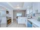 Well-lit kitchen showcasing white cabinets, subway tile backsplash, stainless steel appliances, and dining area in background at 6720 Gilda Dr, Tampa, FL 33625