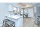 Well-lit kitchen featuring a peninsula bar, stainless appliances, and modern countertops at 6720 Gilda Dr, Tampa, FL 33625