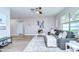 Inviting living room featuring neutral walls, a ceiling fan, and seamless flow into the dining area at 6720 Gilda Dr, Tampa, FL 33625