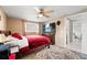 Bedroom featuring a ceiling fan, window, a comfortable bed and dresser with television set at 7631 Ironbark Dr, Port Richey, FL 34668
