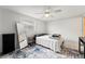 Bright bedroom with a ceiling fan, large window, and stylish rug, offering a cozy and modern space at 7631 Ironbark Dr, Port Richey, FL 34668