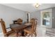 Inviting dining room with elegant wooden table and chairs, adjacent to a sunny outdoor pool area at 7631 Ironbark Dr, Port Richey, FL 34668