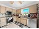 The kitchen is well-equipped with stainless steel appliances, and light colored cabinets at 7631 Ironbark Dr, Port Richey, FL 34668