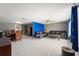 An open living room showing dining area, tile floors, and ceiling fans at 7631 Ironbark Dr, Port Richey, FL 34668