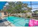 Private in-ground pool surrounded by lush landscaping at 7631 Ironbark Dr, Port Richey, FL 34668