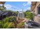 Backyard featuring a storage shed, tropical plants, garden statues, and air conditioning unit at 7802 134Th St, Seminole, FL 33776
