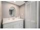 Bathroom with grey walls and a white vanity with a white vessel sink and oval mirror at 7802 134Th St, Seminole, FL 33776