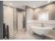 Modern bathroom featuring a glass shower, a standalone tub with classic feet and marble floors at 7802 134Th St, Seminole, FL 33776