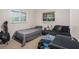 Shared bedroom features twin beds, two windows for light and a guitar for added personality at 7802 134Th St, Seminole, FL 33776
