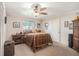 Cozy bedroom features a ceiling fan, a window with decorative bars and a comfortable-looking bed at 7802 134Th St, Seminole, FL 33776