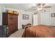 Bedroom features a comfortable bed, wooden wardrobe, and a cozy bench, great for relaxing at 7802 134Th St, Seminole, FL 33776
