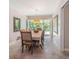 Bright dining room with a large window overlooking a lush garden at 7802 134Th St, Seminole, FL 33776