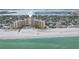 Stunning aerial view of beachfront condo with pool, beautiful sandy beach, and ocean views at 880 Mandalay Ave # C513, Clearwater Beach, FL 33767