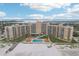 Aerial view of a condo building on the beach with pool at 880 Mandalay Ave # C513, Clearwater Beach, FL 33767