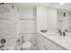 This bathroom features white marble-look tile, a modern vanity, and a toilet, creating a clean and functional space at 880 Mandalay Ave # C513, Clearwater Beach, FL 33767
