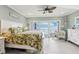 This spacious bedroom has soothing green walls, a plush king bed, and glass doors that open to a balcony with stunning ocean views at 880 Mandalay Ave # C513, Clearwater Beach, FL 33767