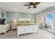 This bedroom boasts calming green walls, an inviting king bed, and sliding glass doors to a private balcony with an ocean view at 880 Mandalay Ave # C513, Clearwater Beach, FL 33767