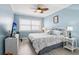 Cozy bedroom with blue walls, ceiling fan, wood-look floors, and a comfy bed with white wicker headboard at 880 Mandalay Ave # C513, Clearwater Beach, FL 33767
