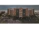 Wide shot of a beachfront condo building, parking lot, and sandy beach at 880 Mandalay Ave # C513, Clearwater Beach, FL 33767