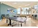 Spacious game room with ping pong table, foosball, seating, and beach view at 880 Mandalay Ave # C513, Clearwater Beach, FL 33767
