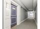 Hallway of condo building with patterned carpet and blue door at 880 Mandalay Ave # C513, Clearwater Beach, FL 33767