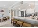 Open floor plan to the kitchen with white cabinets and bar seating at 880 Mandalay Ave # C513, Clearwater Beach, FL 33767
