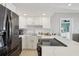 Modern kitchen features stainless steel appliances and white cabinets at 880 Mandalay Ave # C513, Clearwater Beach, FL 33767